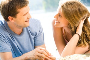 Portrait of woman and man looking at each other outside